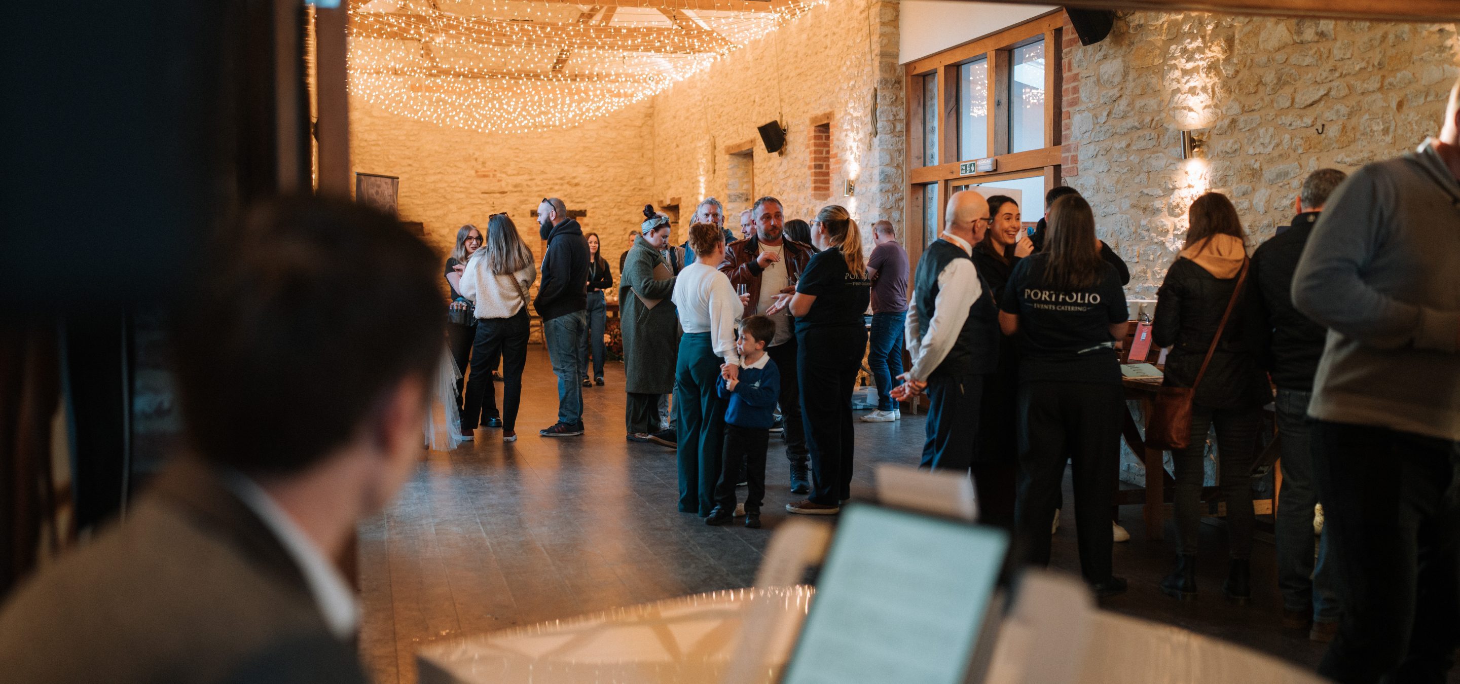 Guests in barn at a wedding open evening