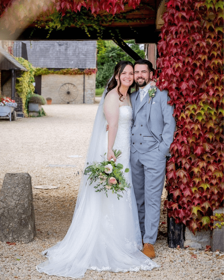 Bride and groom stood outside at barn venue