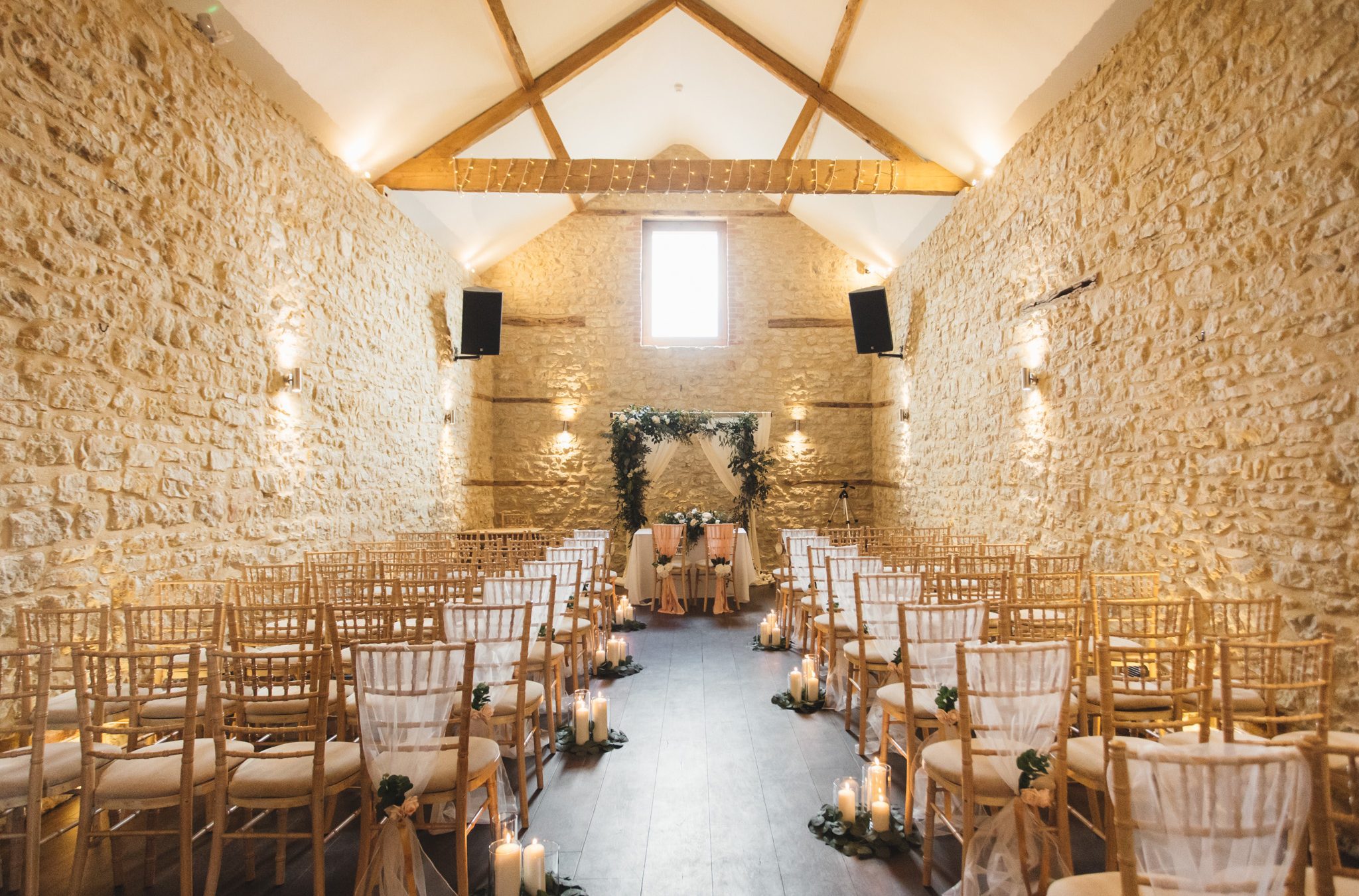 Wedding barn with decorated chairs and candles