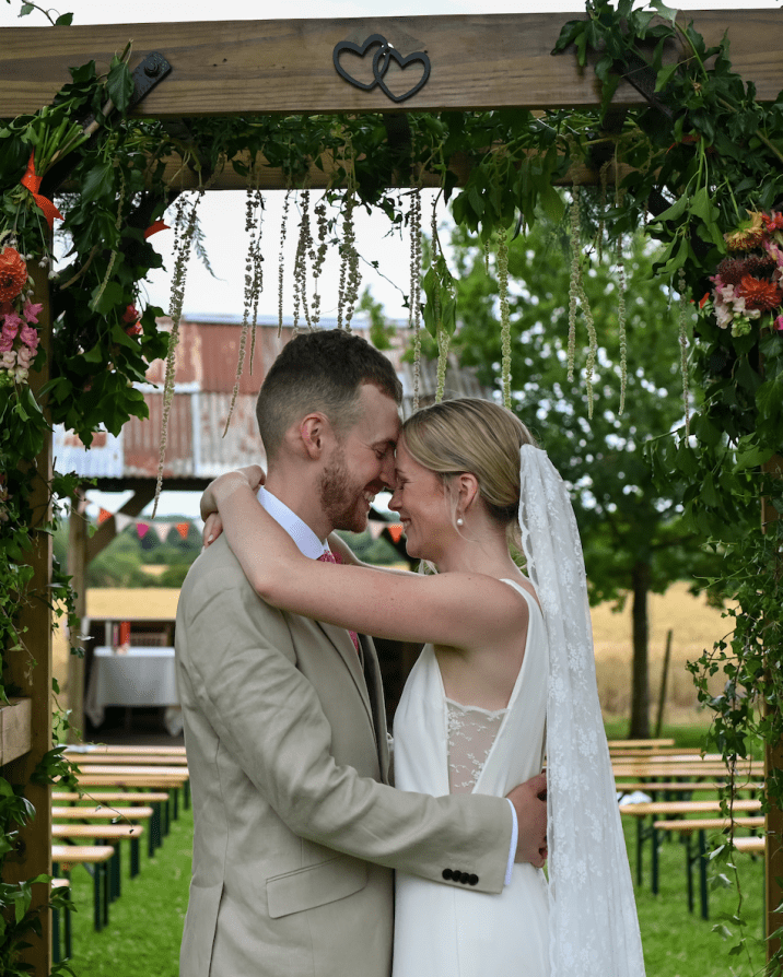 Bride and groom just married under outdoor structuer