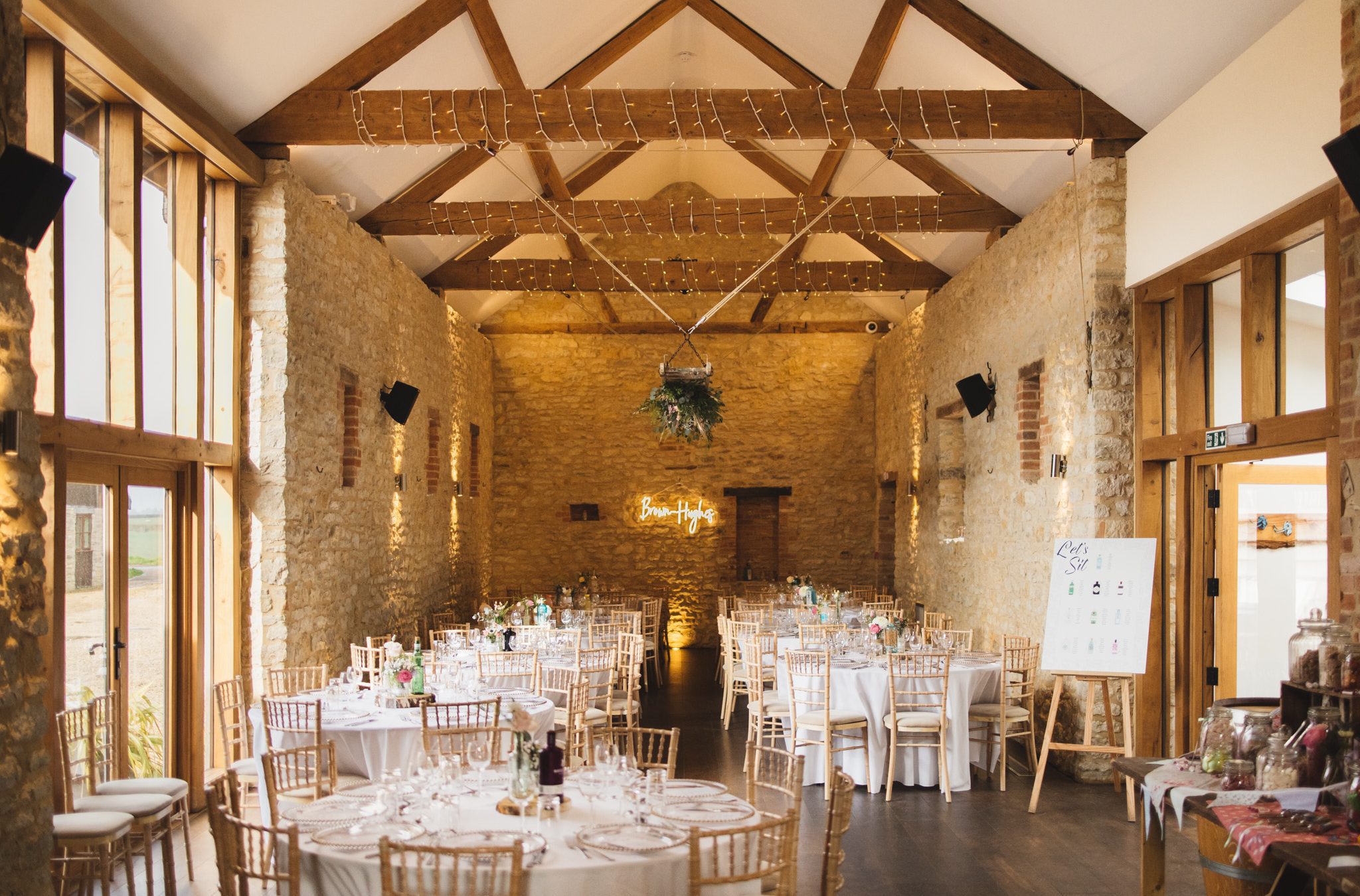 Wedding breakfast round table set up in converted barn