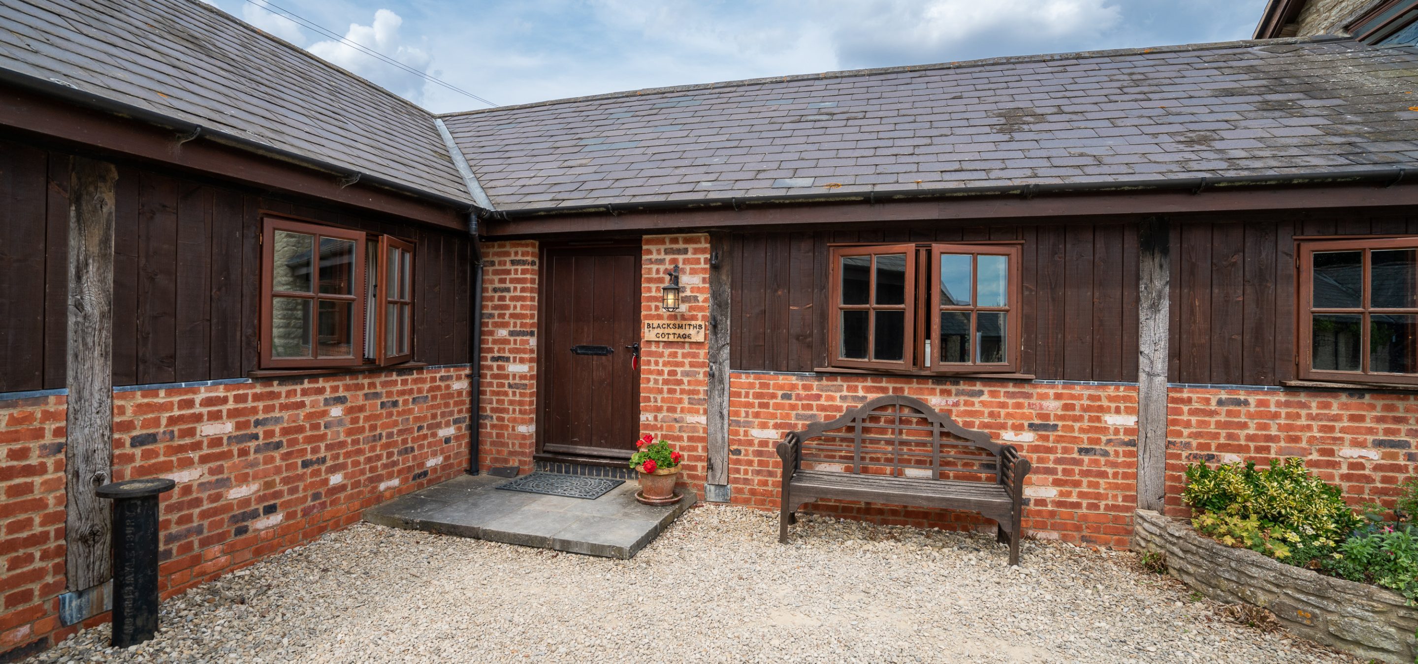 Outside of cottage with brown door and windows