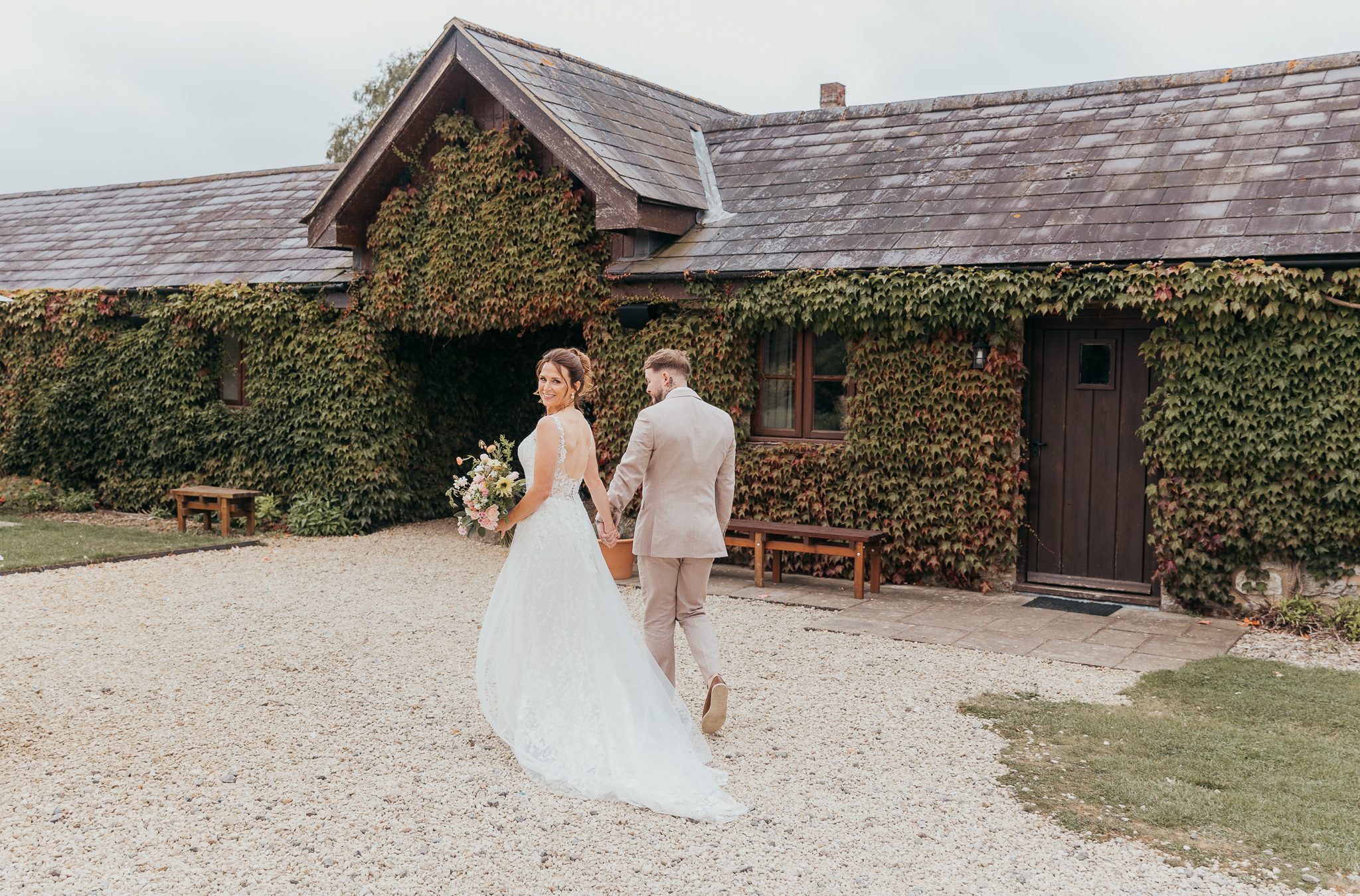 Bride and groom walking around Huntsmill grounds